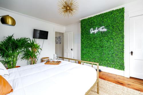 a green wall in a bedroom with a bed at Short North Convention King Bed Free Parking! in Columbus