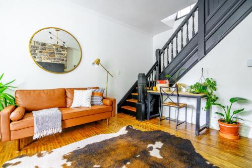 a living room with a couch and a staircase at Short North Convention King Bed Free Parking! in Columbus