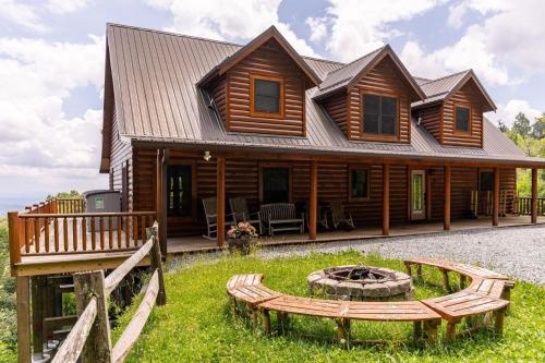a log cabin with a fire pit in front of it at Hidden Ridge in Boone