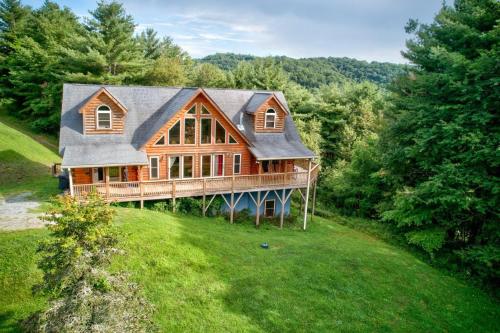 a large wooden house on top of a green field at 1 Awesome Skyview in Vilas