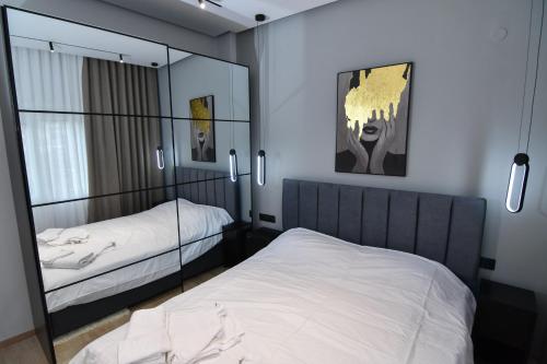 a bedroom with two beds and a mirror at twins luxury studios in Kastoria