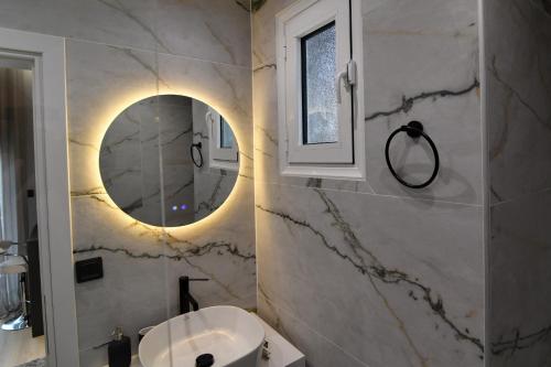 a bathroom with a sink and a mirror at twins luxury studios in Kastoria