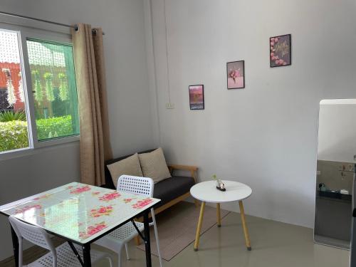 a small living room with a table and a chair at Yada House s&s in Nai Yang Beach