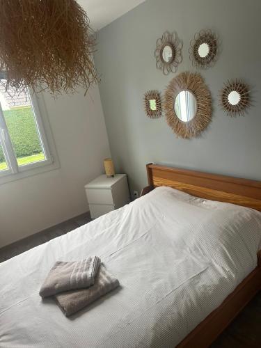 a bedroom with a bed with mirrors on the wall at Maison 3 chambres a 5 min de la mer in Etalondes-la-Pipe