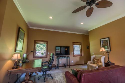 a living room with a couch and a ceiling fan at Stoneledge Manor in Banner Elk
