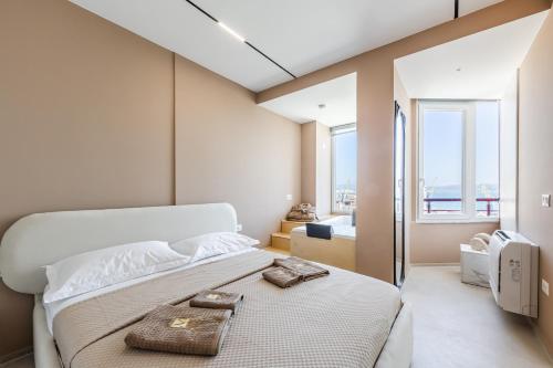 a bedroom with a bed with two towels on it at Marina Luxury Jacuzzi Suites by PS in Durrës