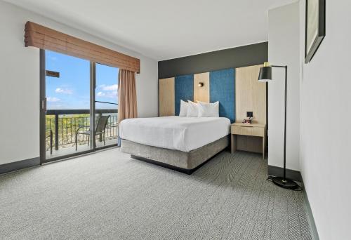 Ένα ή περισσότερα κρεβάτια σε δωμάτιο στο The Jordan Hotel Ramada by Wyndham