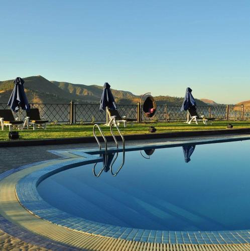 a pool of water with people walking around it at Pyramid Hotels & Resorts in Debre Zeyit