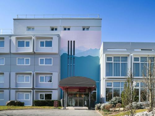 a rendering of a building with a mountain mural at Mercure Annemasse Porte De Genève in Gaillard