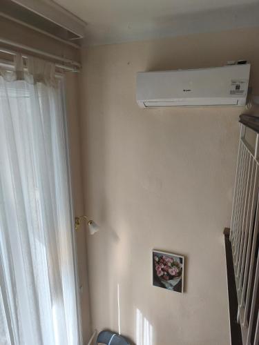 a room with a white ceiling fan and a window at Loft House Budapest in Budapest
