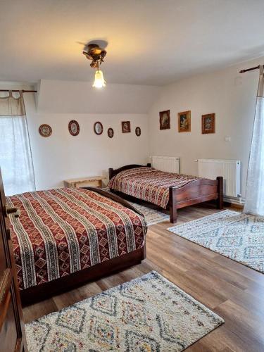a bedroom with two beds and two rugs at Cabana NEDA in Rausor