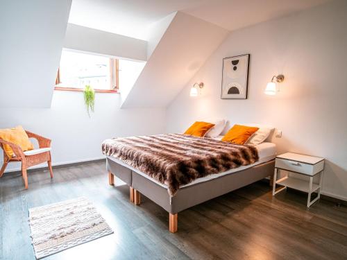 夏蒙尼-勃朗峰Magnifique appartement centre-ville - Animaux admis, WiFi - FR-1-517-37的卧室里有一张带橙色枕头的床