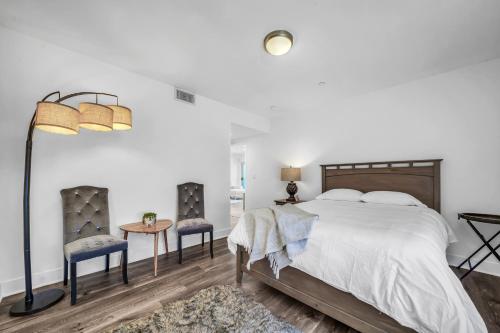 a bedroom with a bed and two chairs and a table at Amazing, Spacious Unit, Heart LA in Los Angeles
