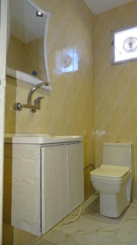 a bathroom with a toilet and a sink at Petra Luminous Apartment in Wadi Musa