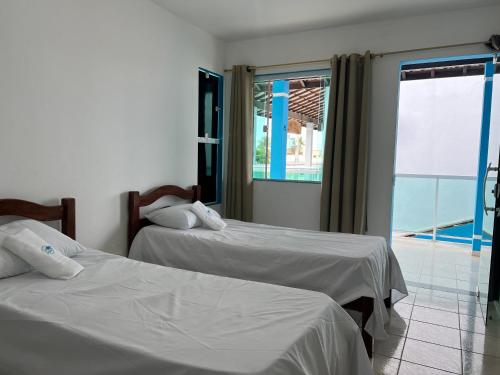 Giường trong phòng chung tại Casa Privativa na Praia dos Carneiros - Cinza