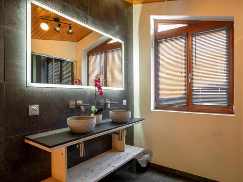 a bathroom with two bowls on a counter with a mirror at Chalet de Luxe à Avoriaz - 12 Pers, Sauna, Cheminée, Services Premium Inclus - FR-1-314-97 in Morzine
