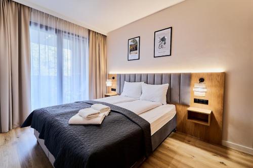 En eller flere senge i et værelse på Polanica Park LAGUNA Apartament 105