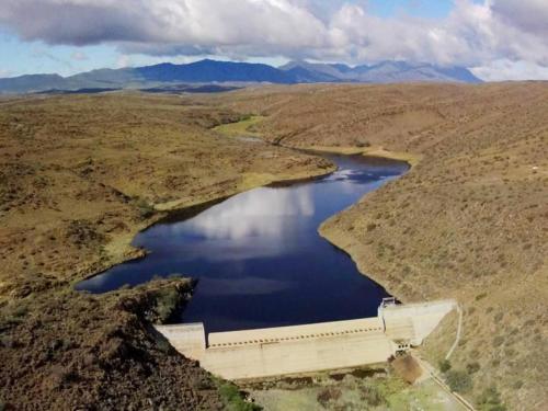 an aerial view of a dam in the middle of a river at Aardvark Bioreserve in Ladismith