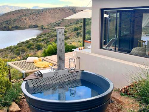 a bath tub sitting on top of a house at Aardvark Bioreserve in Ladismith