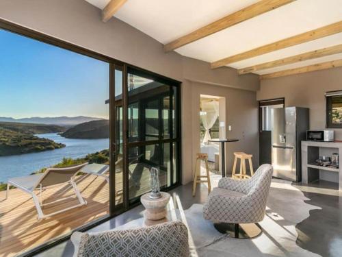 a living room with a view of the ocean at Aardvark Bioreserve in Ladismith