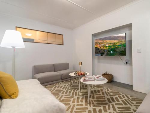 a living room with a couch and a table at Aardvark Bioreserve in Ladismith