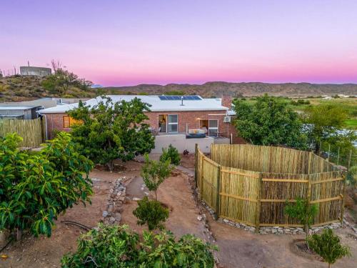 a house with a fence and a garden at Aardvark Bioreserve in Ladismith