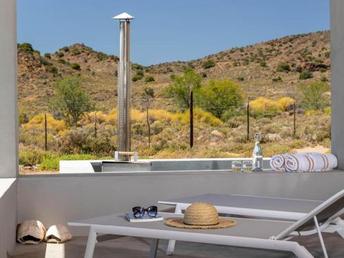 a room with a table and a view of a mountain at Aardvark Bioreserve in Ladismith
