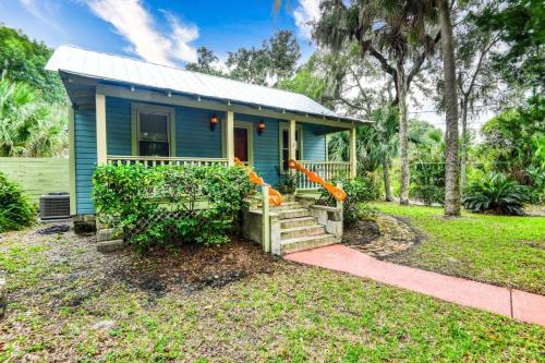 a blue tiny house with a porch at Little Blue Cottage in St. Augustine