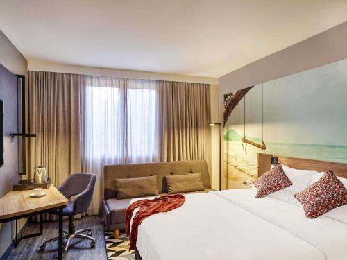 a hotel room with a bed and a desk at Novotel Sao Jose dos Campos in São José dos Campos