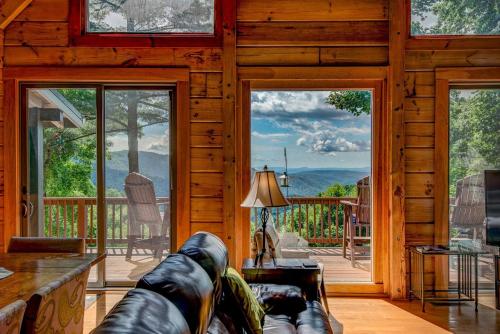 a living room with a couch and a large glass door at 1 Sublime View in Boone