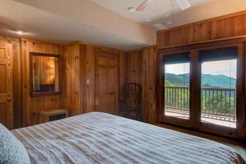 a bedroom with a bed and a view of a mountain at 1 Sublime View in Boone