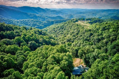 an aerial view of a forest with a house in the middle at 1 Sublime View in Boone
