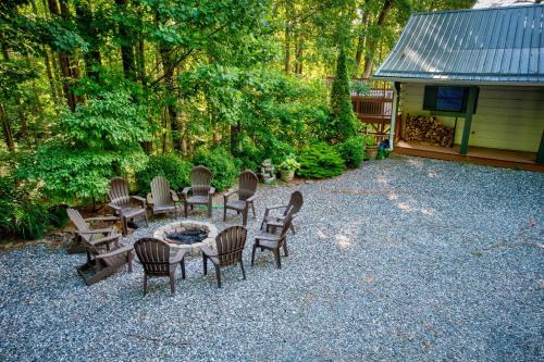 a backyard with chairs and a table and a fire pit at 1 Sublime View in Boone