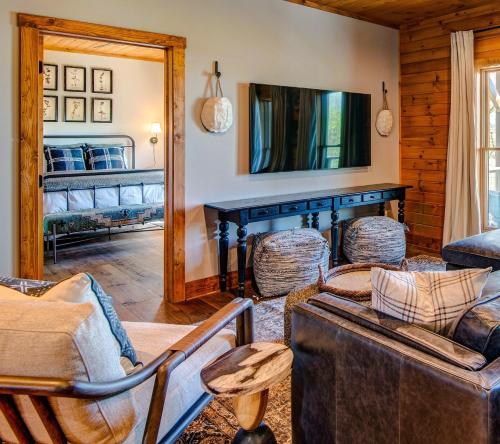 a living room filled with furniture and a mirror at Owls Nest in Seven Devils