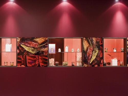 a row of windows in a room with red lights at Mercure Hotel Düsseldorf Neuss in Neuss