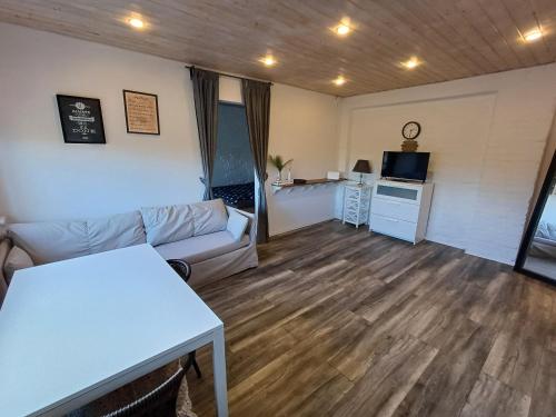 a living room with a couch and a table at Two room apartment near buss station and border in Narva