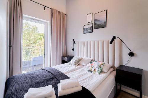 Ένα ή περισσότερα κρεβάτια σε δωμάτιο στο LAGUNA Apartament Polanica Residence 63-SPA