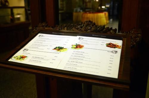 a menu on a table with food on it at City River Hotel in Siem Reap