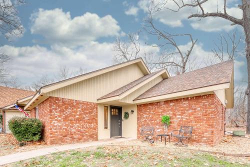 a brick house with two chairs in front of it at Modern Bentonville Retreat - Sleeps 6 Near Trails in Bentonville