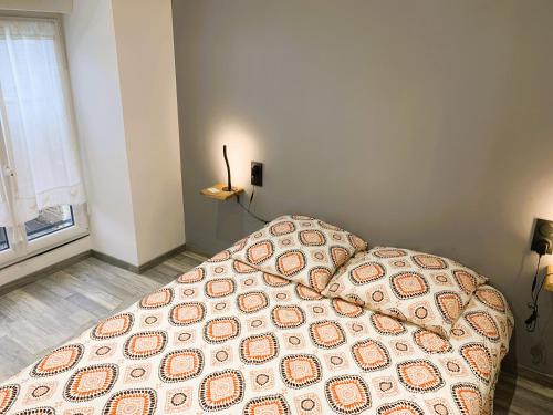 a bedroom with a bed with a blanket on it at Le gîte du Plessis in Montanel
