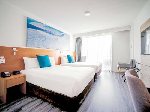 Postel nebo postele na pokoji v ubytování Novotel Cairns Oasis Resort