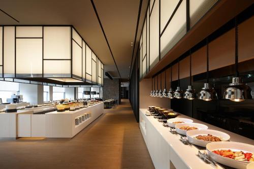 a large kitchen with many plates of food on display at Shilla Stay Cheonan Asan - Samsung Display City in Cheonan