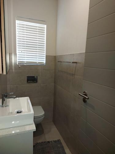 a bathroom with a sink and a toilet and a shower at Unit 48 1onYork in George