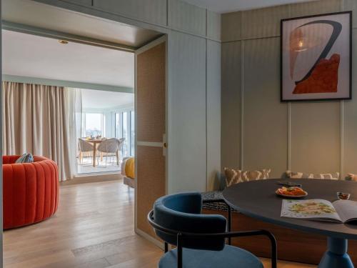 a room with a table and chairs and a dining room at Mercure La Rochelle Vieux Port in La Rochelle
