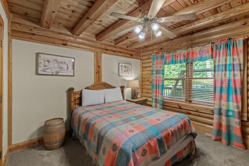 a bedroom with a bed and a ceiling fan at Sugar Bear Lodge in Banner Elk
