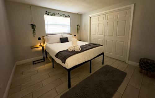 a bedroom with a bed with two candles on it at Chic & Stylish House In Tampa Ybor&busch in Tampa