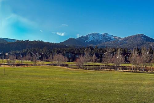 a green field with mountains in the background at Snowcreek #059 Near Shuttle & Activities in Mammoth Lakes