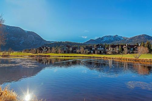 a body of water with houses and mountains in the background at Snowcreek #059 Near Shuttle & Activities in Mammoth Lakes
