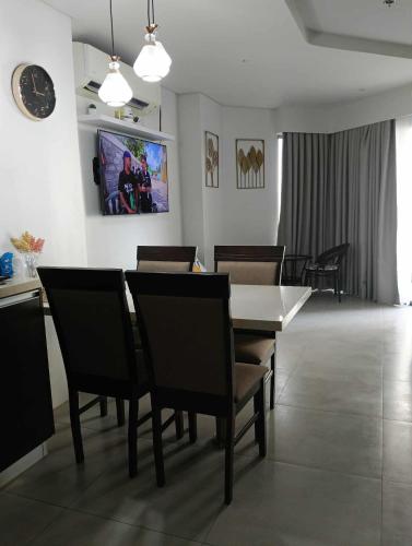 a dining room with a table and chairs at Tambuli Resort Tower D in Lapu Lapu City