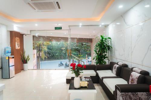 a living room with a couch and a table at Victoria Hotel Me Tri in Hanoi